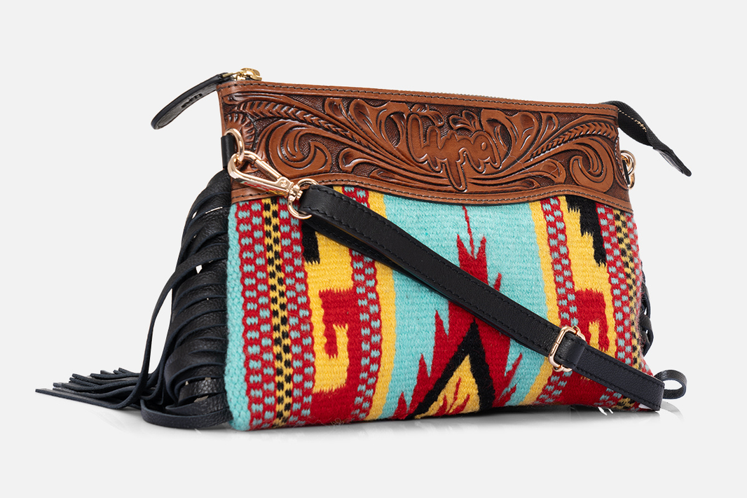 Hand-tooled leather detail representing the vaquero craft tradition