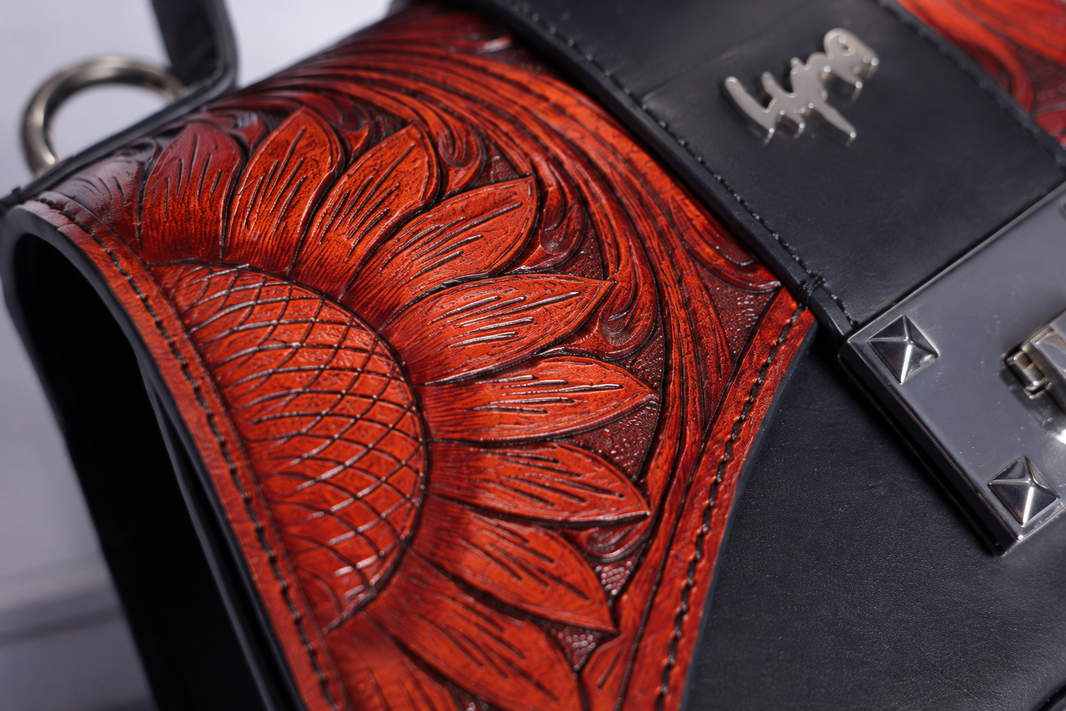 Close-up of genuine hand-tooled leather showing natural depth variation from hand carving