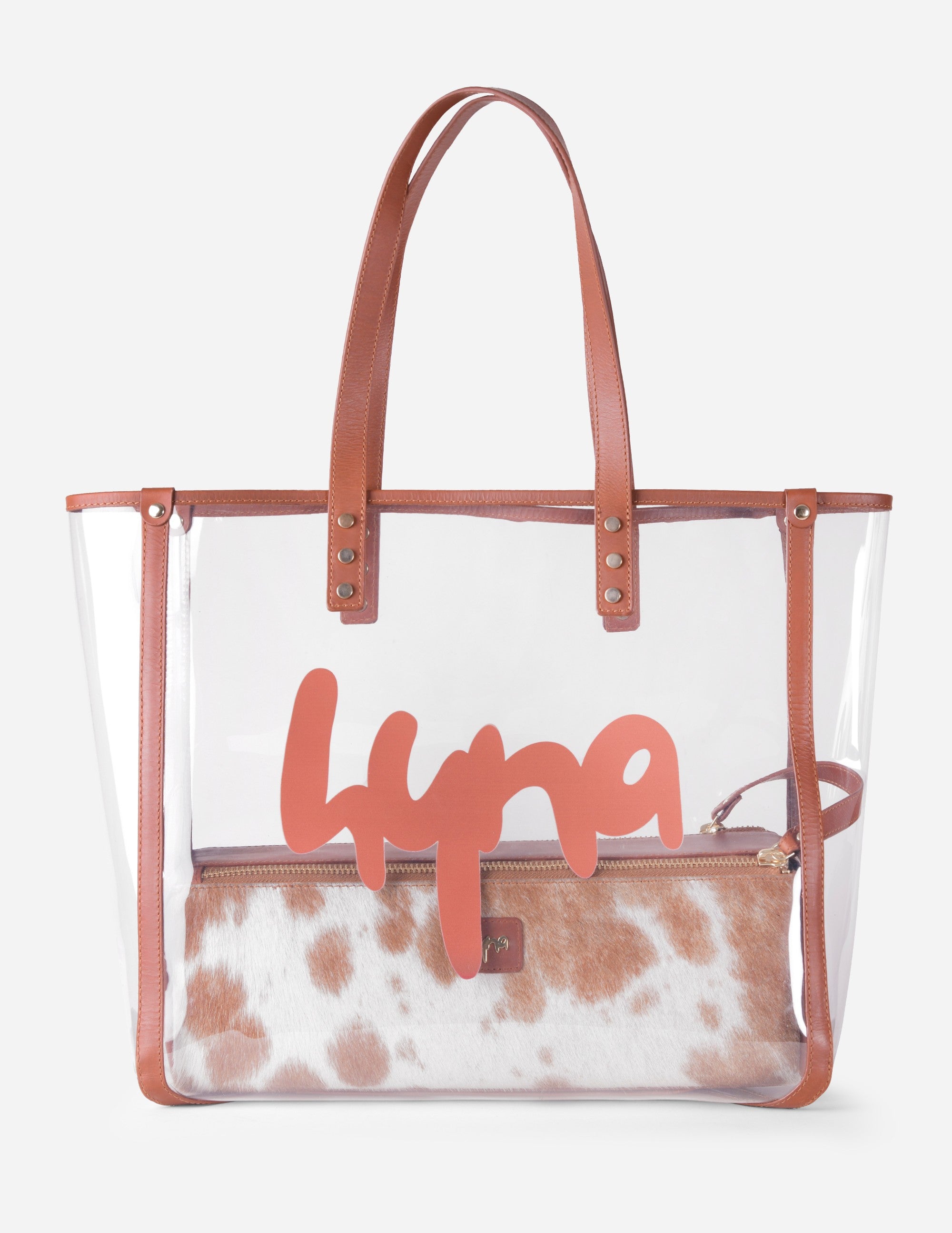 Leather clear bag with brown handles and cow print interior on a white background